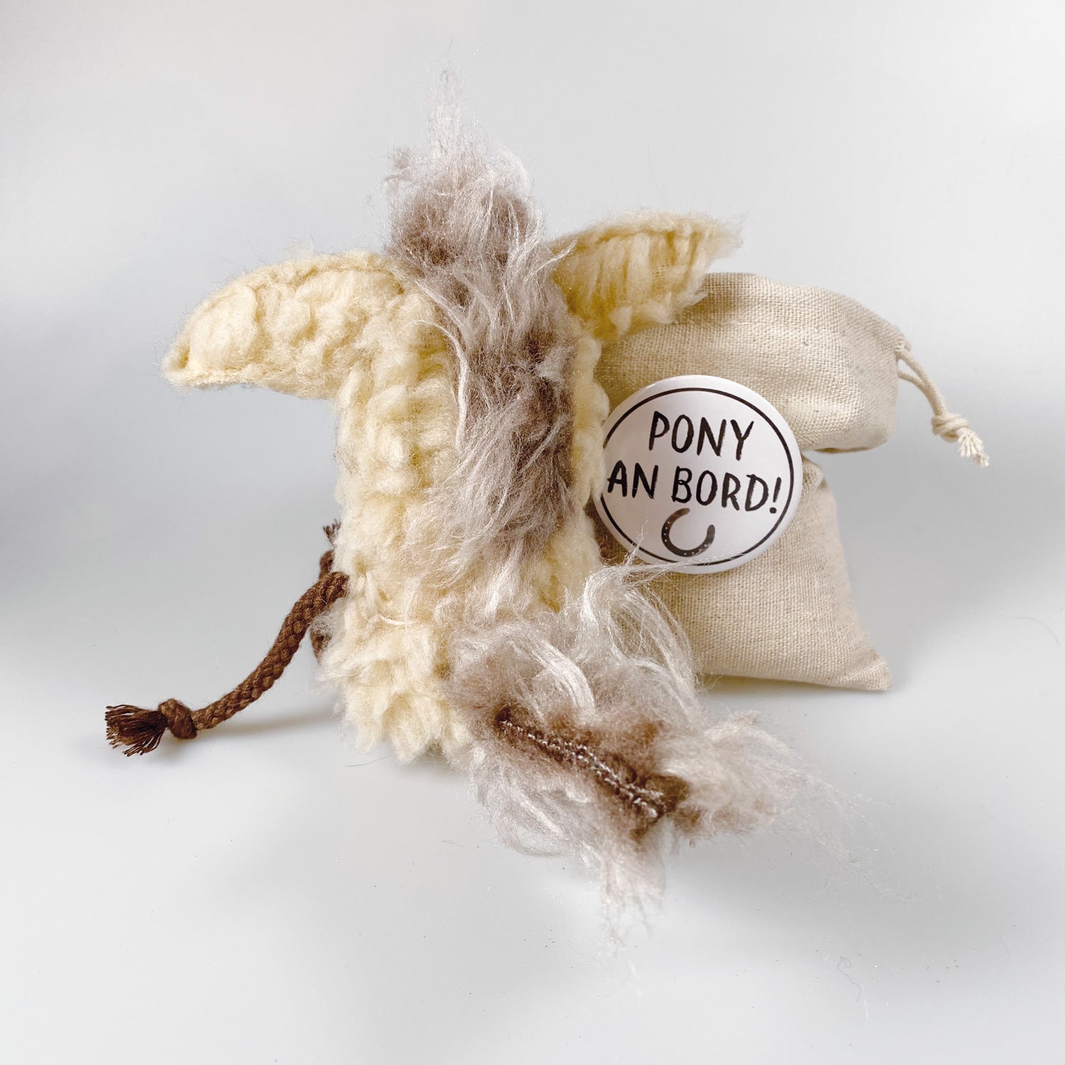 Soft toy pony in a bag “Dante”